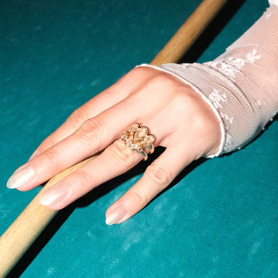 Model wears Cloud Ring / Oval Rose Cut Diamonds with nesting diamond wedding band on ring finger