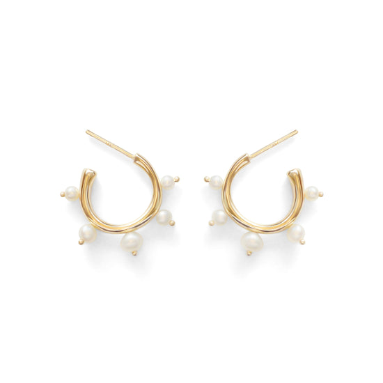 A pair of Amorphous yellow gold hoop earrings with pearls.